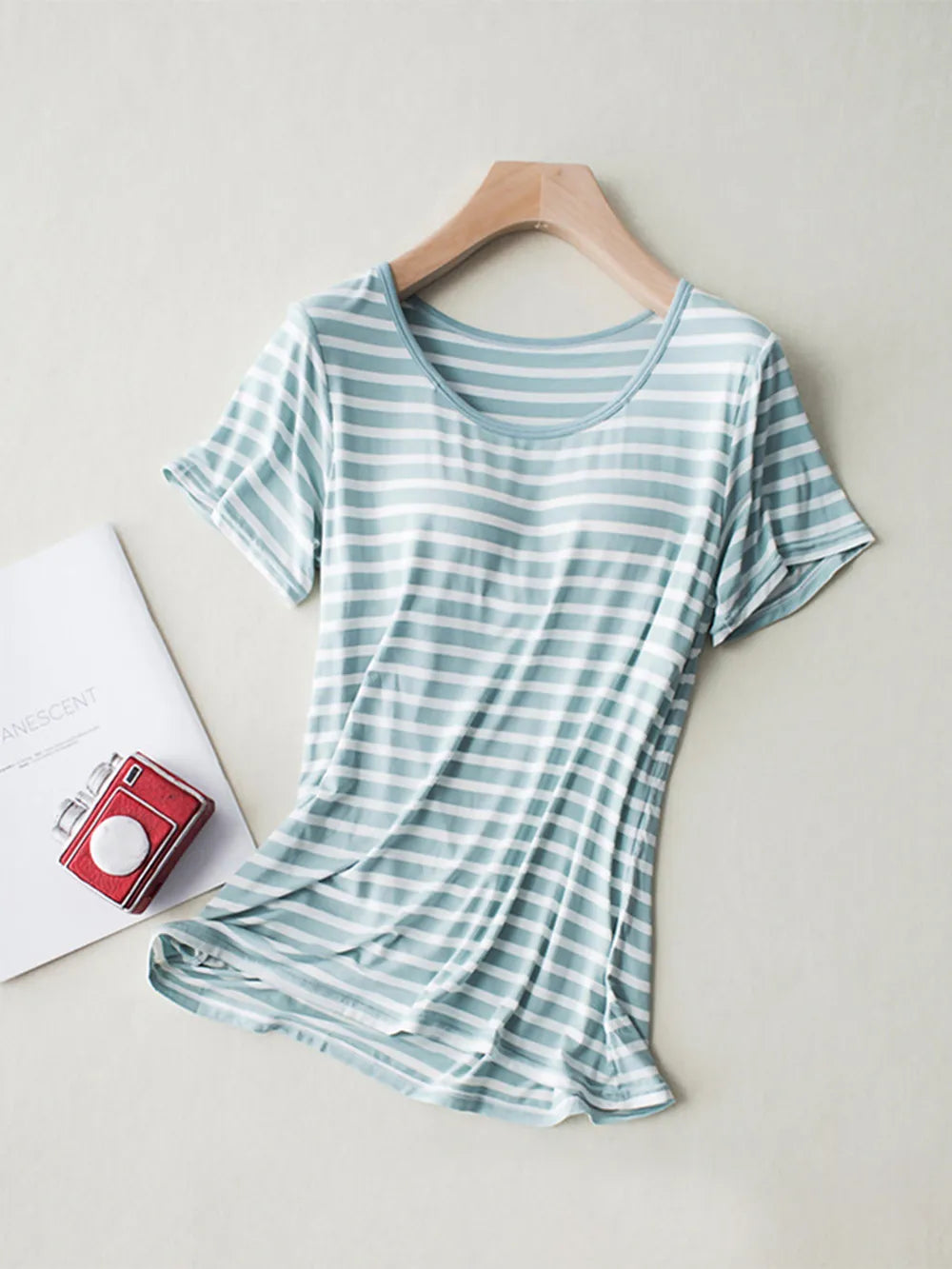 Sage green striped short-sleeve shirt on hanger