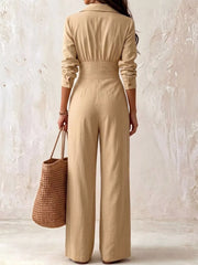 Back view of beige wide-leg jumpsuit with fitted waist
