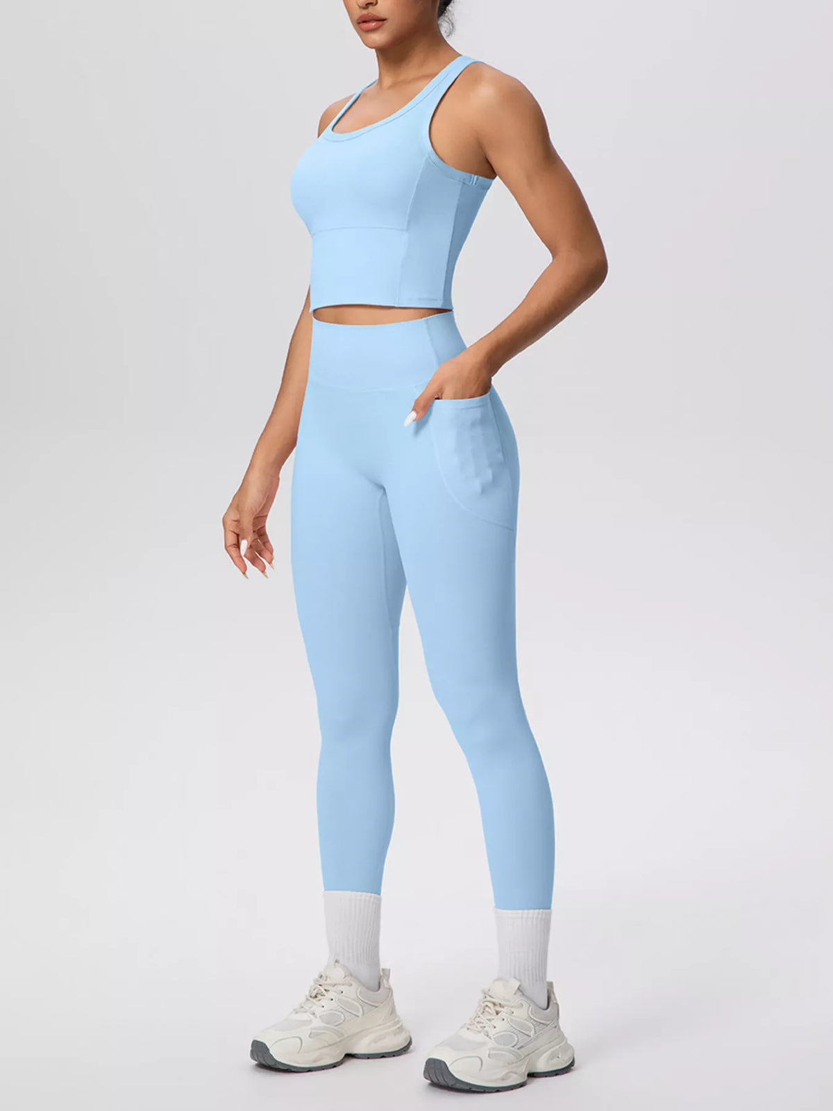 Light blue tank and leggings from a three-quarter front angle