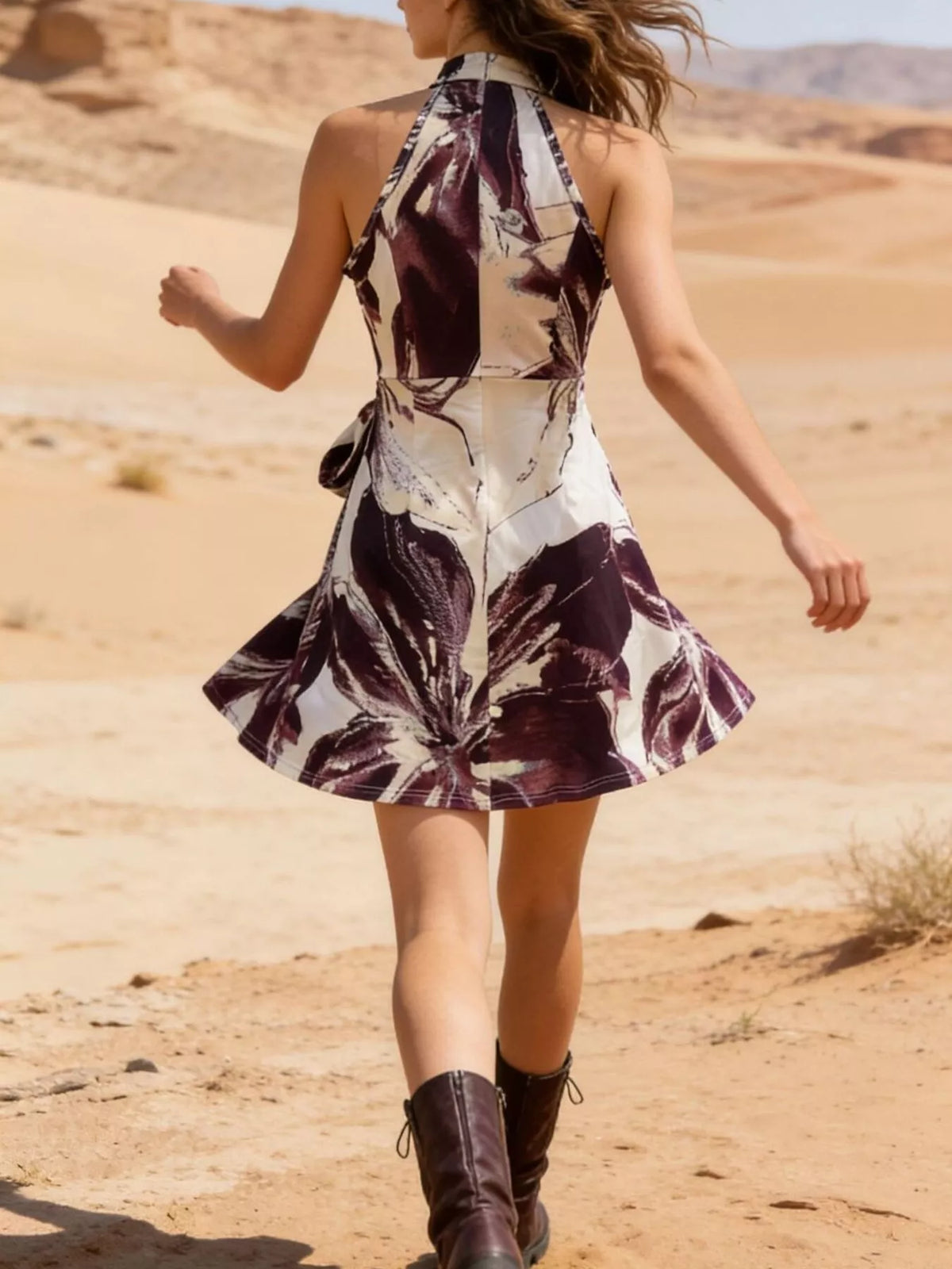 Back view of the halter mini dress showing its high neckline and flared skirt.