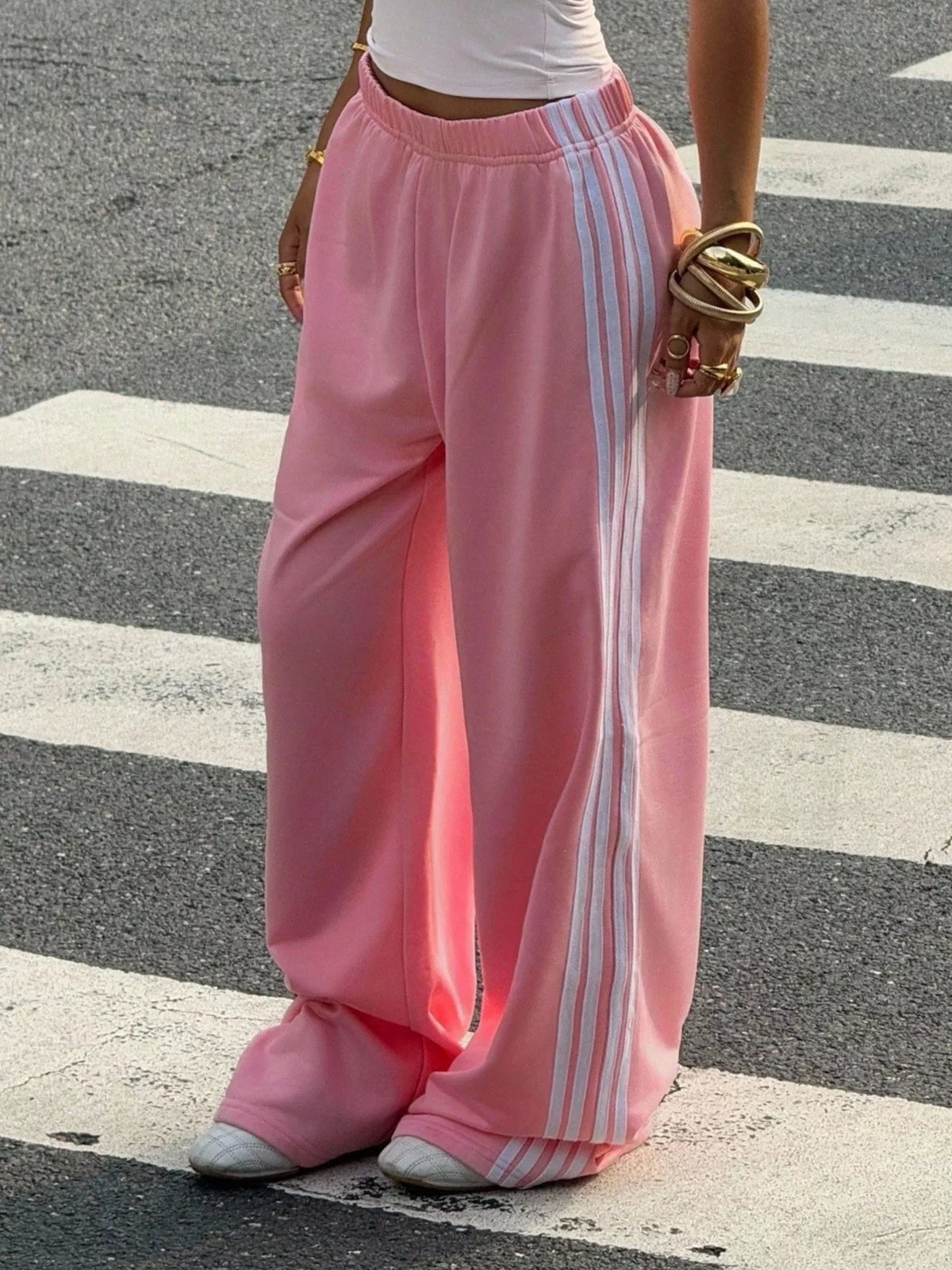 Pink wide-leg track pants shown from the back