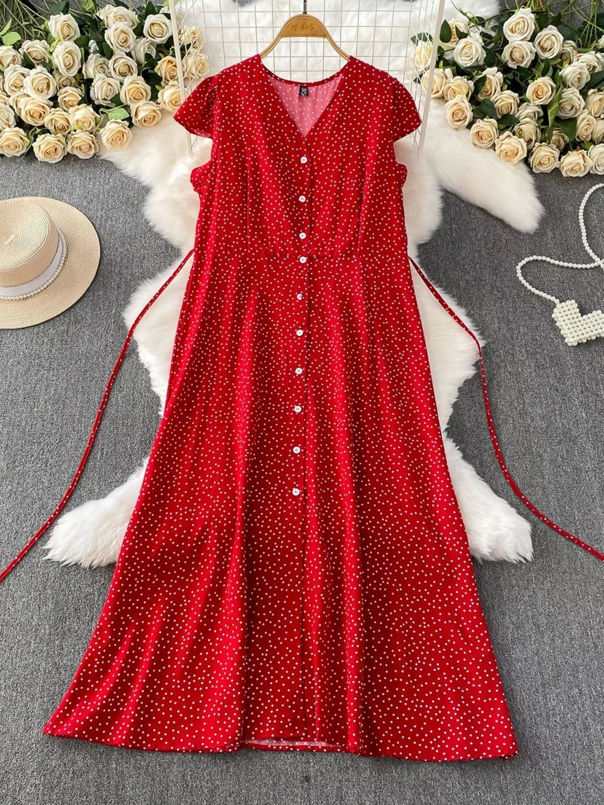 Red polka-dot dress showing button front and tie waist
